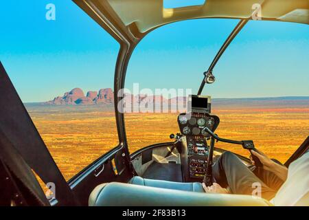 Scenic flight over Kata Tjuta. Helicopter cockpit aerial view of Mount Olga rock formation in Uluru-Kata Tjuta National Park, Northern Territory Stock Photo