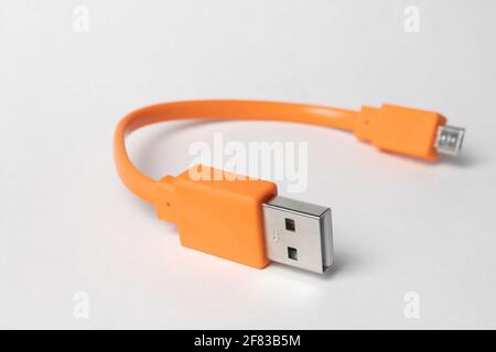 Orange USB micro-usb cabel isolated on grey background Stock Photo