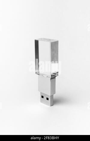 Glass transparent USB drive with metal insert isolated on grey background. Layout. Copy space. A high resolution. Stock Photo