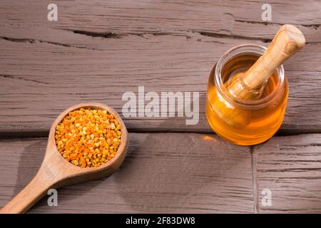 Bee honey and pollen grains. Natural sweetener Stock Photo