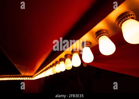 circus lights in a row on red ceiling Stock Photo