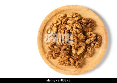 Walnuts in wood plate  isolated on white background. healthy nuts concept. Walnuts are an excellent source of antioxidants and including LDL cholester Stock Photo