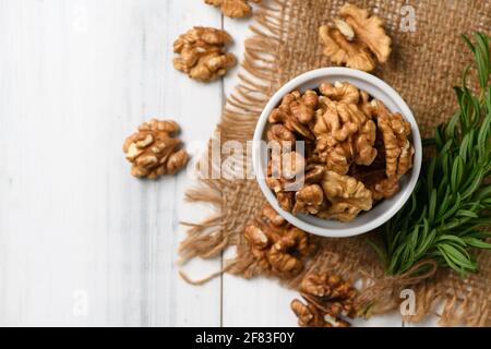 Top view of Walnut in white cup on wood background. healthy nuts concept. Walnuts are an excellent source of antioxidants and including LDL cholestero Stock Photo