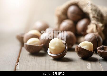 Peeled macadamia nuts  on wood background, Macadamia nuts are loaded with flavonoids and tocotrienols and rich in heart-healthy monounsaturated fats Stock Photo