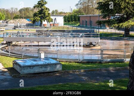 Round sedimentation tanks full of wastewater in a water treatment facility Stock Photo