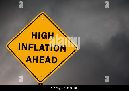 High inflation ahead conceptual warning road sign with stom sky in background Stock Photo