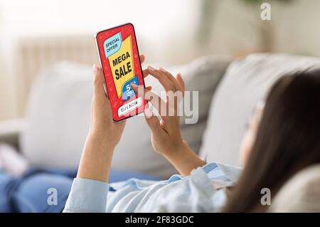 Closeup of feman hands holding smartphone with shopping application Stock Photo