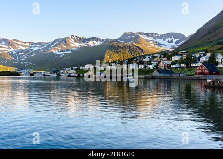 Small fishing town in a narrow fjord on the northen coast of Iceland on a clear summer day Stock Photo