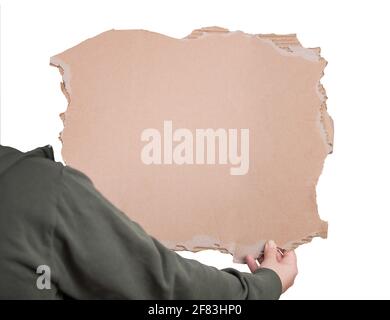 Activist hand holding a blank cardboard sheet, participating in a street demonstration or protest. Blank banner for advertising and messages isolated Stock Photo