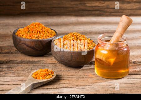 Bee honey and pollen grains. Natural sweetener Stock Photo