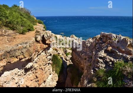 MELLIEHA, MALTA - Sep 21, 2015: The cliffs and rock faults along the Ahrax tal-Mellieha and Ghadira Bay in Malta, on a sunny day in summer. Evidence o Stock Photo