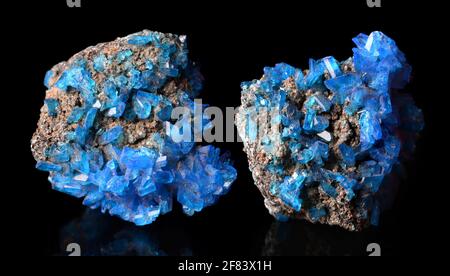 Blue mineral crystals Covellite on a black background. Stock Photo