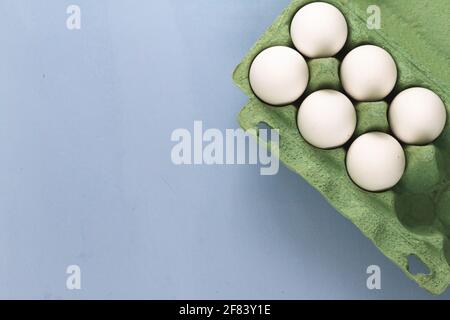 group of white chicken eggs on light blue background, empty space for text Stock Photo