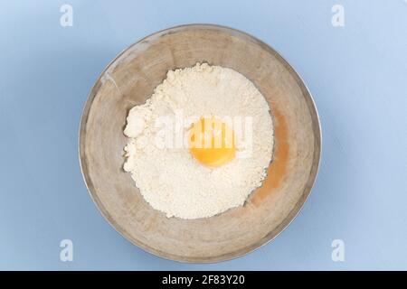 pastry preparation, broken egg with flour in a bowl Stock Photo