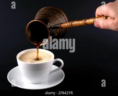 Freshly Brewed Coffee Poured into white cup Stock Photo