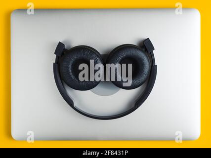 Headphones lie on notebook. Stock Photo