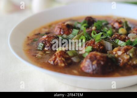 Veg Manchurian. A tasty Indo Chinese dish with fried vegetables balls in a spicy, sweet and tangy sauce. The vegetable ball is made of cabbage, carrot Stock Photo