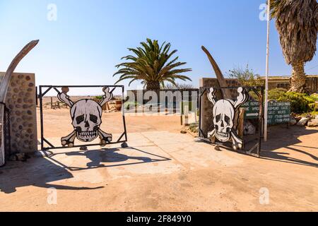Ugabmund Gate with its famous skull-and-crossbones, at the entrance to the Skeleton Coast National Park, Namibia. Stock Photo