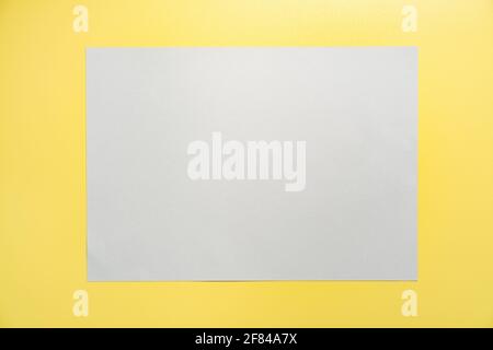 Gray frame on yellow background. Creative Flat lay Top view Mockup Copy space for text. Trendy colors 2021. Stock Photo