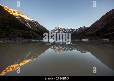 Mount Cook in morning light, sunrise, reflection in Hooker Lake with ice floes, alpenglow, Mount Cook National Park, Southern Alps, Hooker Valley Stock Photo