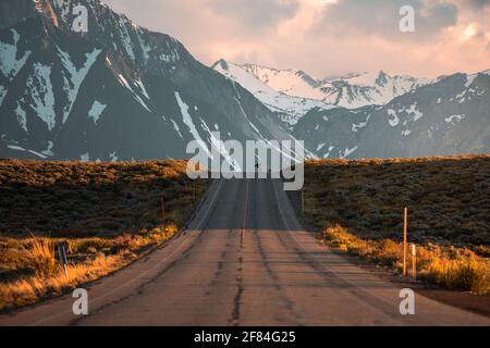 Stunning Sierra Nevada Mountain Landscape Background - Man Skating Down Hill Stock Photo