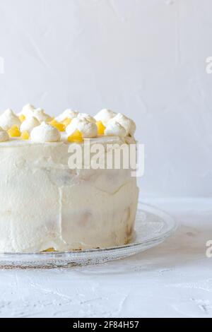 Lemon Victoria Sponge Cake decorated with dots of mascarpone cream and lemon curd. Stock Photo