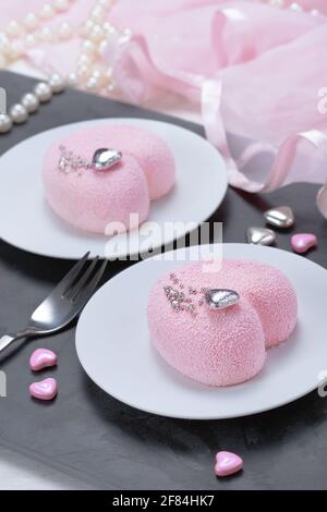 Little pink mousse cakes in the shape of a heart . St. Valentine's Day Stock Photo