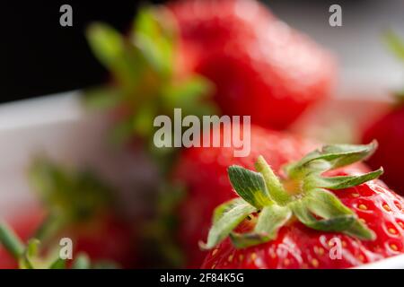 Strawberry macro texture. Background of red ripe berries. Delicious juicy strawberries close up in selective focus. The concept of summer, freshness, Stock Photo