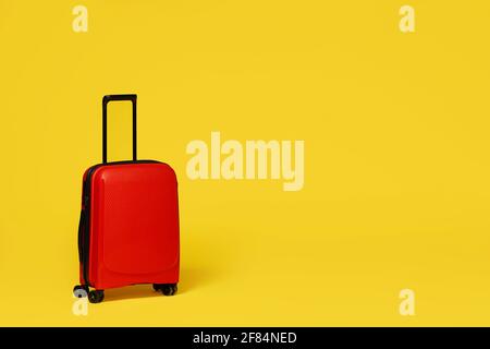 stylish suitcase for travelling on yellow background. Stock Photo