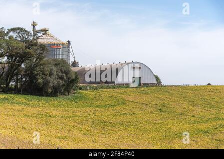 Large agricultural granary for grain storage. construction in which cereals, straw and other provisions are kept; storage of groceries; magazine. Stock Photo