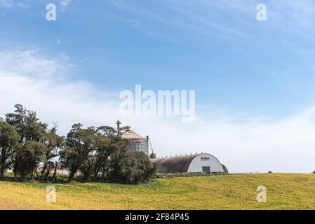 Large agricultural granary for grain storage. construction in which cereals, straw and other provisions are kept; storage of groceries; magazine. Stock Photo