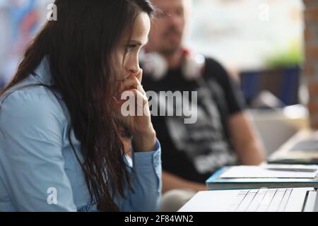 Portrait of nervous female employee sitting at working place Stock Photo