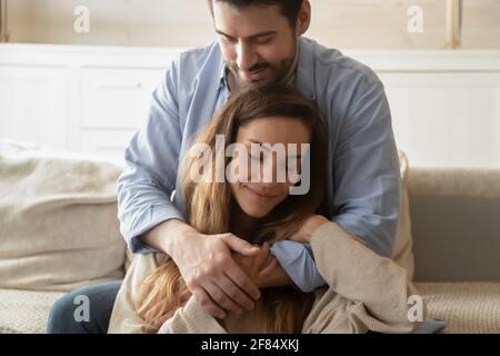 Young Caucasian couple hugging cuddling at home Stock Photo