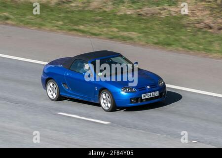 2005 cool blue MG Tf 135 sportscar driving on the M6 motorway near Preston in Lancashire, UK. Stock Photo