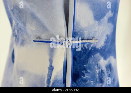 Cloth button, called a Pankou in Chinese, on a traditional Chinese female dress known as a Qipao at an exhibition in Beijing. Stock Photo