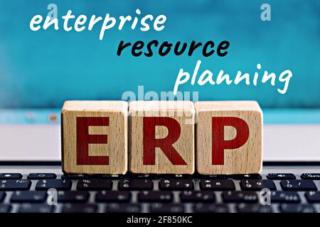 photo on erp (enterprise resource planning) theme. wooden cubes with the abbreviation "erp", and the inscription "enterprise resource planning", on bl Stock Photo