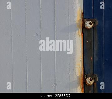 Two locks seen on a wooden door. Stock Photo