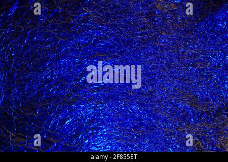 Abstract red and blue aluminum wrinkled foil background texture reflecting  red and blue light Stock Photo - Alamy