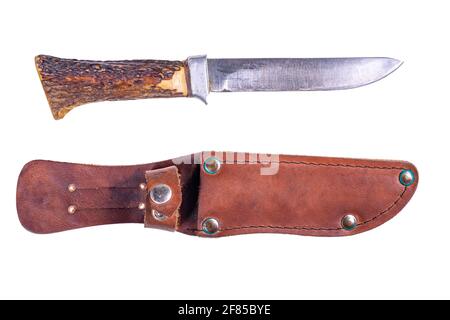 A hunting knife with a leather scabbard and a deer horn handle. Accessories for hunters hunting deer. Isolated background. Stock Photo