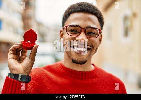 Handsome african american young man holding engagement ring Stock Photo