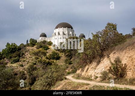 Looking up at Griffith Observatory from east hiking trail in Griffith Park, a popular loop for exercise with social distancing in Los Angeles Stock Photo