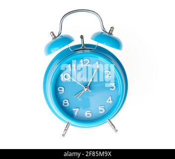Hand of hispanic man holding blue alarm clock over isolated white background. Stock Photo