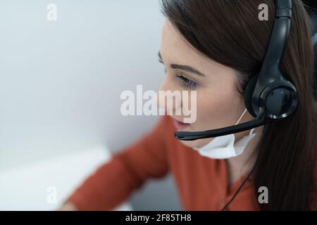 call center operator in medical mask Stock Photo