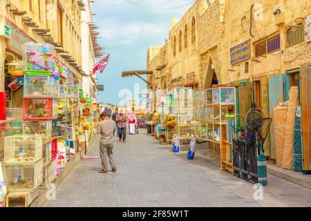 Doha, Qatar - February 19, 2019: pet shop and cages along pedestrian street inside Bird Souq, the old animal market and popular tourist attraction in Stock Photo