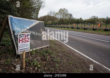 Wendover, UK. 9th April, 2021. Signs reading 'Environmental Disaster?' and 'Stop HS2' are pictured opposite a site currently being cleared of trees and vegetation by HS2 contractors on 9th April 2021 in Wendover, United Kingdom. Tree felling work for the project is now taking place at several locations between Great Missenden and Wendover in the Chilterns AONB, including at Jones Hill Wood. Credit: Mark Kerrison/Alamy Live News
