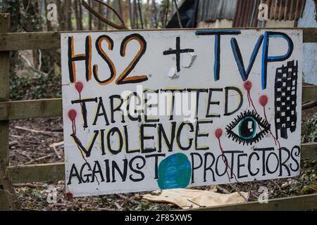 Wendover, UK. 9th April, 2021. A sign suggesting that HS2 and Thames Valley Police use 'targeted violence' against tree protectors is pictured outside Wendover Active Resistance Camp, which is occupied by activists opposed to the HS2 high-speed rail link. Tree felling work for the project is now taking place at several locations between Great Missenden and Wendover in the Chilterns AONB, including opposite the camp. Credit: Mark Kerrison/Alamy Live News