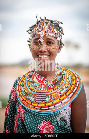 young Maasai woman in traditional clothes, necklaces and heardgear Stock Photo