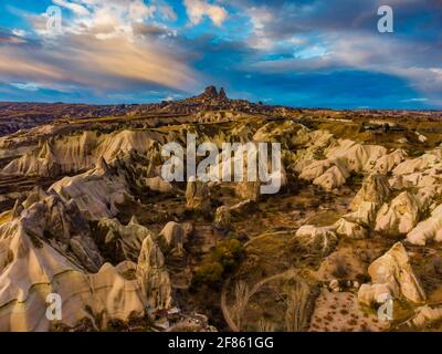Near Goreme, we can also found spot the nearest town - called Uchisar. The fortress on the top of the pointy hill is illuminated at night and it gives Stock Photo
