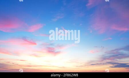 defaultBeautiful morning clear sky background. Colorful yellow blue sky. Morning colorful clear blue sky background with soft white clouds sunrise or Stock Photo