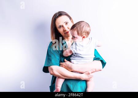 Hospital doctor holding a six month old baby infant hospital concept for children Stock Photo